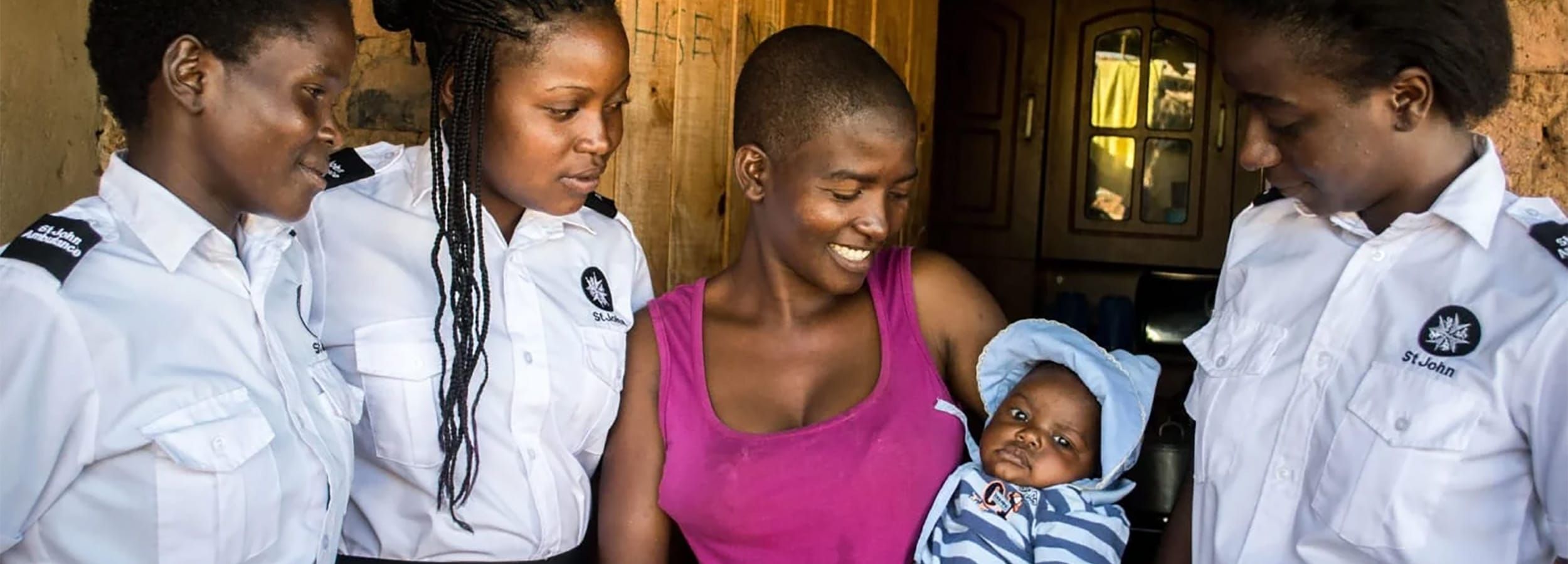 mother and baby with aid workers